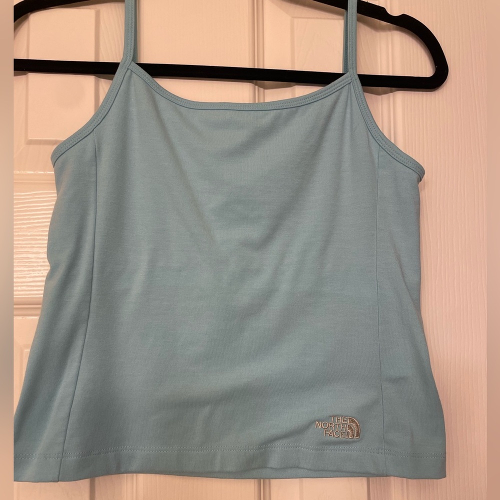 The NorthFace size Medium cropped tank top. Lined. Baby blue color. Work out top